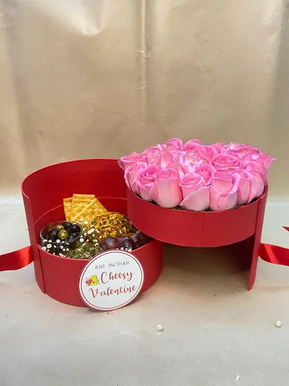 For my cheesy Valentine. This clever two-tiered box reveals a mini cheese platter in one compartment and a bouquet of pink roses in the other.