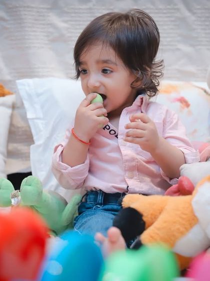 A toddler surrounded by his favorite toys. Incorporating personal items makes the photoshoot even more special and meaningful.