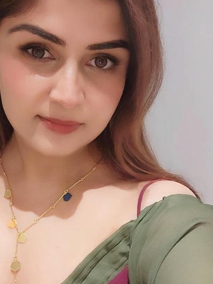 A portrait shot highlighting the makeup and accessories that complement the colorful resort wear.