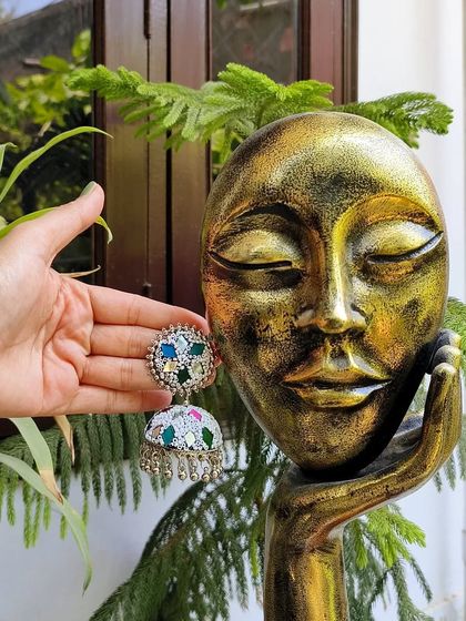 This multicolour mirror work jhumka in green and other hues is perfect for adding a playful touch to your look.