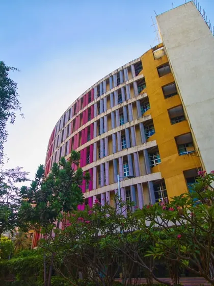 This perspective of the K.J. Somaiya College building shows its harmonious relationship with the surrounding green landscape. Our design philosophy ensures that even large urban structures are thoughtfully sited to preserve and enhance the natural environment, creating a complete and balanced campus experience.