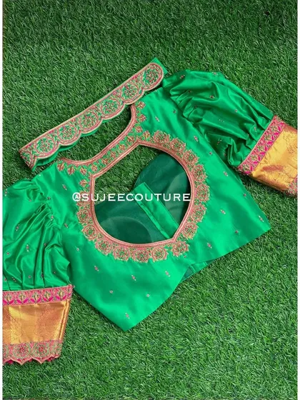Another view of the green puff sleeve blouse, showing the included embroidered vaddanam (belt) that perfectly matches the detailing on the blouse.