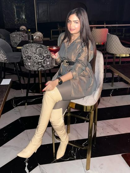 A sophisticated winter look featuring a sheer grey top and thigh-high boots. This outfit is perfect for a stylish evening out.