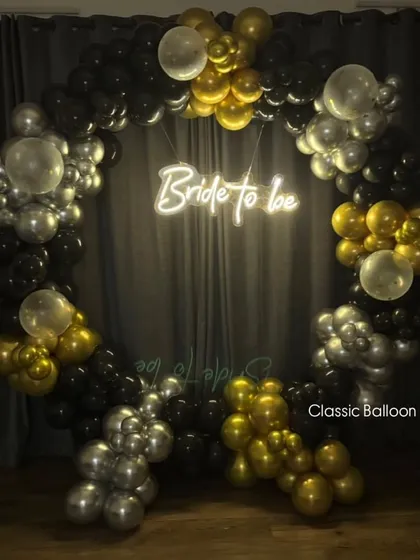 The same 'Bride to be' backdrop shown in low light, highlighting the effect of the bright neon sign. This creates a perfect, glamorous atmosphere for evening celebrations.