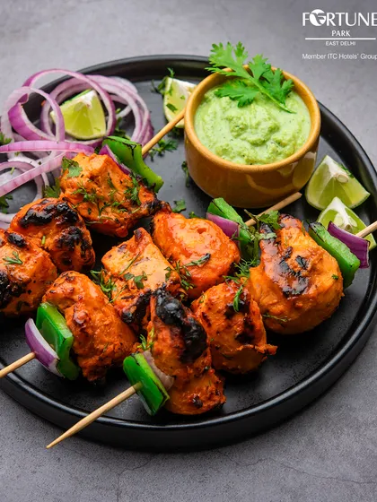 We present our classic Chicken Tikka, grilled to perfection. Each succulent piece is marinated in a blend of traditional spices, offering an authentic taste of India with a touch of modern culinary flair.