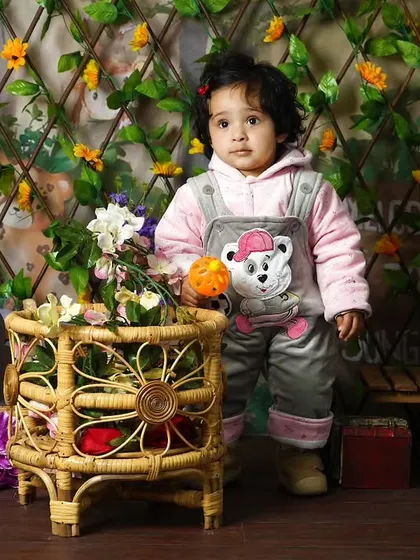A pre-birthday photoshoot with a garden theme. I use natural elements like a vine-covered trellis and wicker baskets to create a rustic and charming setting.