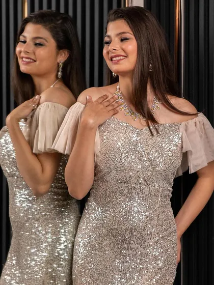 A close-up of the silver sequin gown, showing the beautiful sparkle and flattering fit. You can rent this celebrity-inspired look for your next big event.