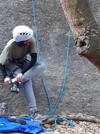 Shivani getting her climbing shoes on, a familiar ritual for any climber. It's the quiet moment of preparation before the focus of the climb begins.