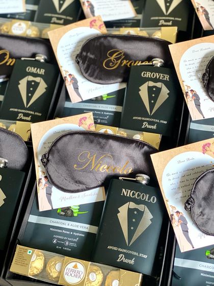 The details matter! I make sure every groomsman's name is perfectly placed on their personalized gifts, like these custom eye masks and hip flasks.