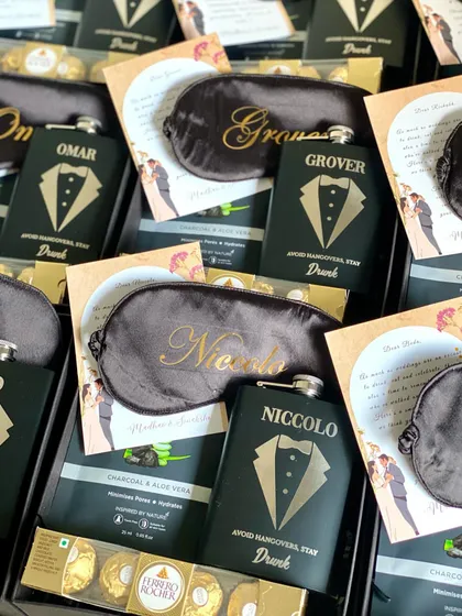 The details matter! I make sure every groomsman's name is perfectly placed on their personalized gifts, like these custom eye masks and hip flasks.