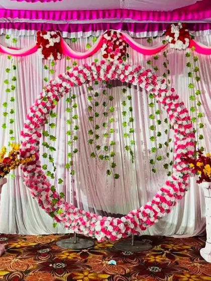 To show my range beyond balloons, here is a traditional circular arch I created for a Ganesha festival celebration. The entire ring is covered in pink and white flowers, with hanging green vines providing a beautiful, classic backdrop for any cultural or religious event.