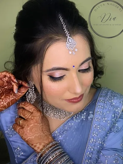 Another angle of this beautiful reception makeup. The soft pink shimmer on the eyelids and the perfectly placed maang tikka complete this polished and glamorous look.