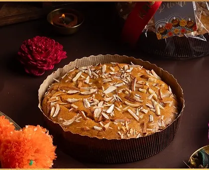 A close-up of our Vanilla Almond and Orange Tea Cake, a centerpiece of our healthy Diwali hampers. It's moist, flavourful, and topped with crunchy almonds.