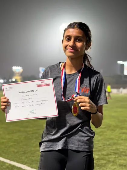 Sanika proudly holding her certificate and medal after winning at her Annual Sports Day. Her focus and determination in the 100m and relay events were outstanding.