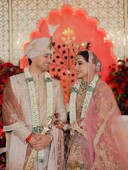 A beautiful candid moment between the bride and groom on their wedding stage. Their shared smile and loving gaze capture the happiness of their union.