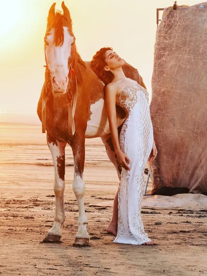A truly magical shot with Alaya F and a horse at sunset. I chose this elegant white and gold gown to create a breathtaking, ethereal moment that feels like it's straight out of a fairytale.