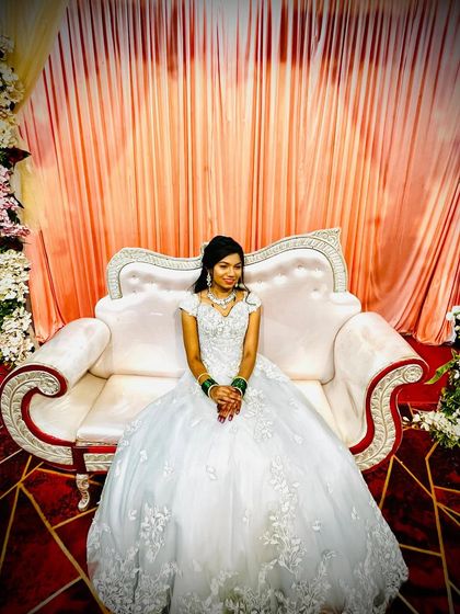 This white ball gown is a classic choice for a reception or a Christian wedding. The full skirt and detailed bodice are simply timeless.