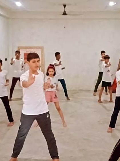 Students practicing a basic block. The concentration is visible.