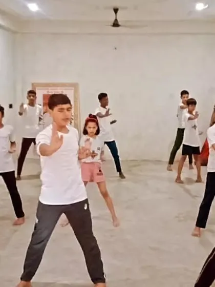 Students practicing a basic block. The concentration is visible.