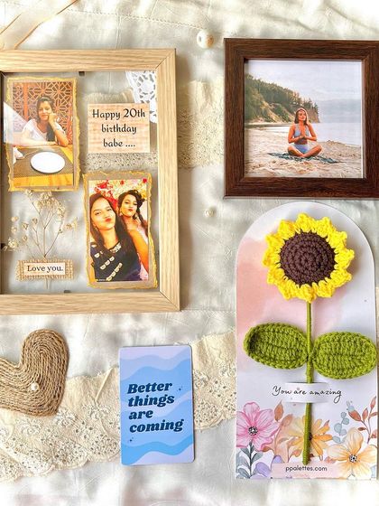 A collection of personalized gifts, including a custom photo frame, a single sunflower card, and a positive affirmation note.