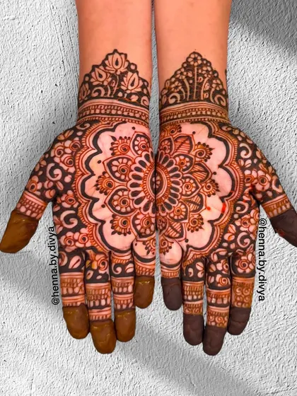 A full-palm symmetrical mandala design. The two hands come together to form a complete, intricate circle, symbolizing unity and wholeness.