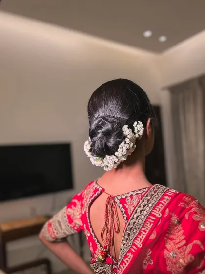 The side profile of this classic gajra bun shows its perfect shape and how it provides a beautiful base for the wedding veil.