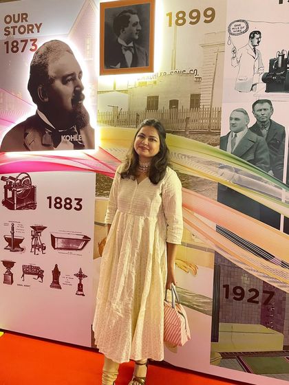 Posing with the history wall at the Kohler event. It was fascinating to immerse myself in their 150-year story before bringing it to life with sand.