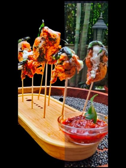 Juicy chicken skewers marinated in a flavorful sauce and grilled to perfection. The split-screen effect highlights the dish both in a studio setting and as part of an outdoor event.