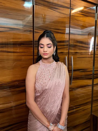 A moment of quiet reflection before the ceremony. The soft lighting highlights the flawless makeup and the elegant details of her Roka look.
