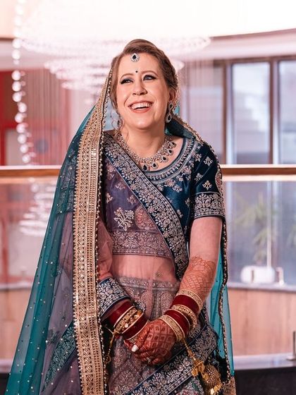 The pure joy on a bride's face. This candid shot captures a moment of unrestrained happiness during her wedding celebration.