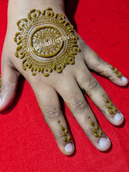 A simple mandala design for a child's hand. It's a quick and pretty option that kids love.