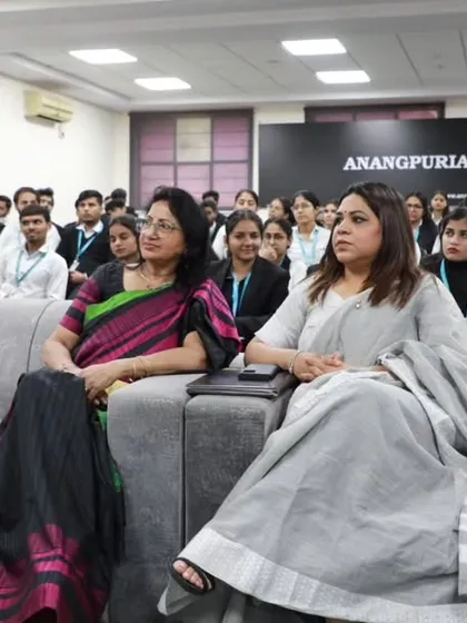 Seated in the front row with faculty, listening to the seminar proceedings. Engaging with both students and educators is key to fostering a robust legal education system.
