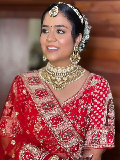 My bride Khushi, looking radiant for her wedding. I gave her a classic bridal look with softly defined eyes and a warm skin finish to complement her red lehenga.