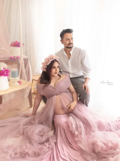 A dreamy, romantic portrait of a couple in our studio. The soft mauve gown, floral crown, and light-filled setup create an ethereal and gentle atmosphere, perfectly capturing their connection.