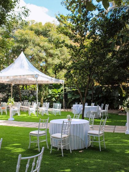 A collection of stunning wedding setups at The Farmhouse Collective. You can see the venue's versatility, from elegant morning ceremonies with floral mandaps to glamorous evening receptions with fairy lights and chic decor. This space is a blank canvas for your dream outdoor wedding in Bengaluru.