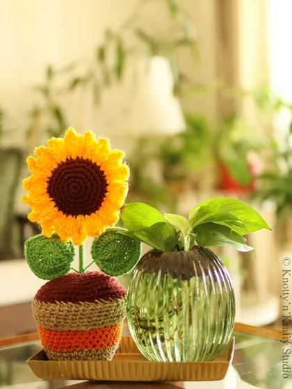 A sunflower vignette, with my crochet sunflower placed next to a real plant. The handmade bloom adds a touch of texture and everlasting color.