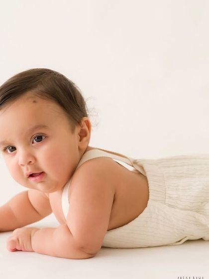 Tummy time pro. Even a simple tummy time pose can create a beautiful portrait, capturing his curious gaze as he looks towards the camera.