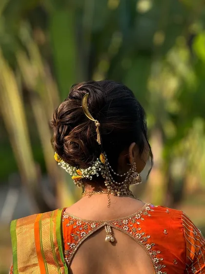 A detailed look at a traditional Maharashtrian bridal bun. I've used a combination of fresh flowers and a crescent-shaped 'chandrakor' pin to create an authentic and beautiful look.