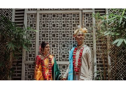 A wide shot of the couple standing before an intricate wall panel. I like to incorporate interesting architecture and backgrounds into my compositions.