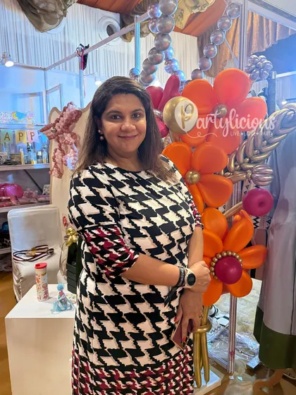 Here I am at our exhibition stall at The Pink Post Inc. I love meeting clients and sharing the magic of what we do. The large balloon flower sculpture behind me was a huge attraction.