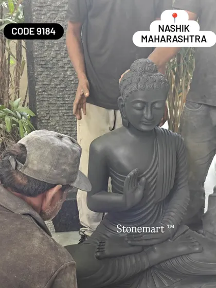 A close-up of the final inspection of the black marble Buddha before it is packed for dispatch to Nashik.