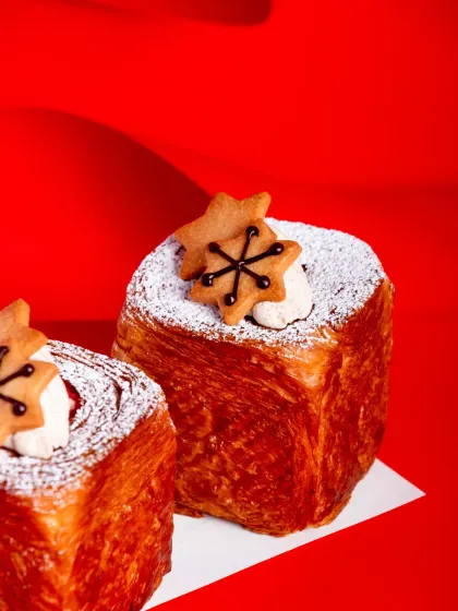 Our Spiced Cranberry Croissant Cubes, topped with a cookie star and a dusting of icing sugar.