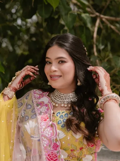 A close-up of the Mehendi look, showing the soft, shimmery eye makeup and the natural, dewy finish of the skin.