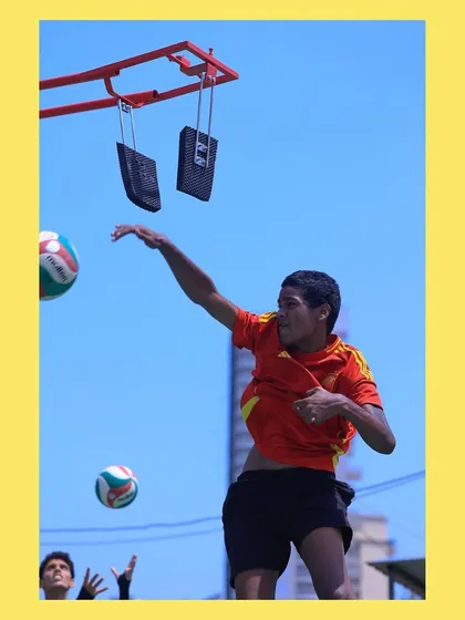 A player executes a powerful spike using our specialized training equipment. This tool helps develop vertical jump and arm swing mechanics for maximum impact.