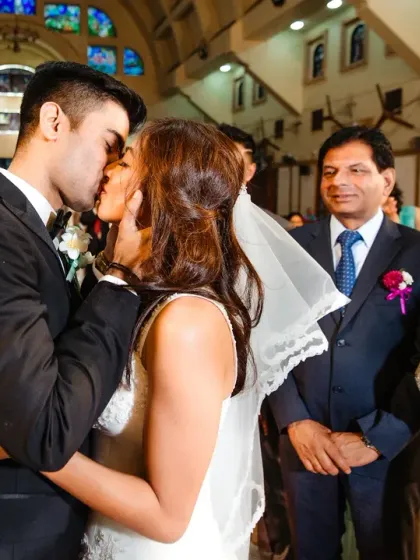 The first kiss as husband and wife, with the proud and happy parents looking on. I love capturing these layered moments where so much is happening at once.