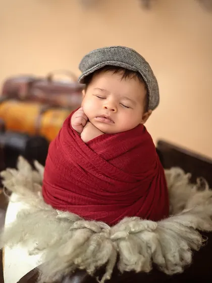 A sweet close-up of baby Ridhaan in his travel-themed shoot, perfectly posed with his hand by his cheek, dreaming of adventures to come.