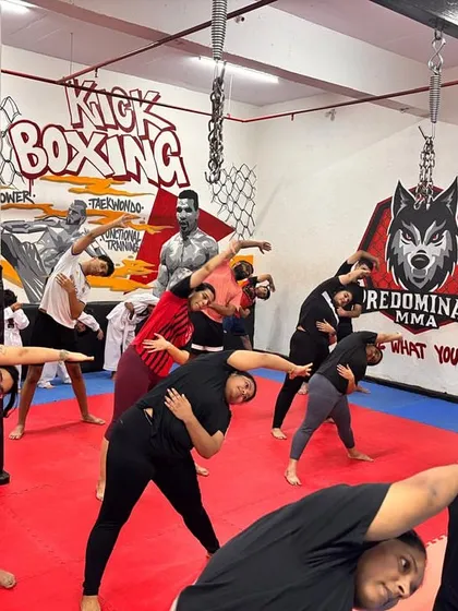 Here, my class moves together during a fusion workout segment. We combine dance fitness with other exercises, like these synchronized side stretches, to improve coordination and work your core muscles.