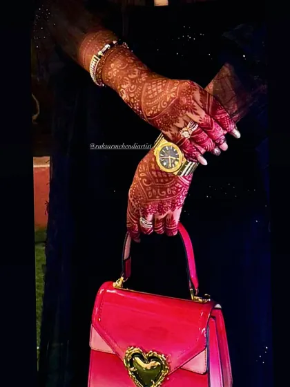 The rich color of the henna stain makes the intricate geometric and floral patterns stand out beautifully.