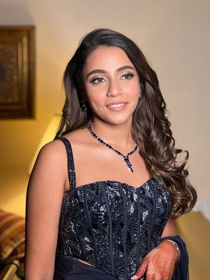 Another beautiful shot of this bride's cocktail look. The soft waves in her hair and the glowing skin create a look that is both modern and timelessly elegant.