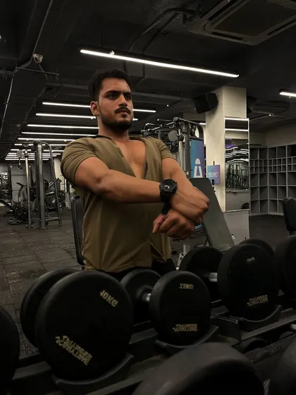Posing after a chest workout to see the pump. Consistent training leads to visible results.